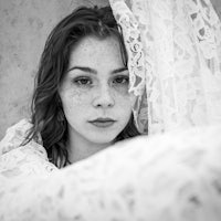 a black and white photo of a woman with freckles